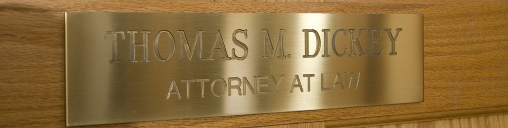 gold door plaque of Thomas M. Dickey law offices